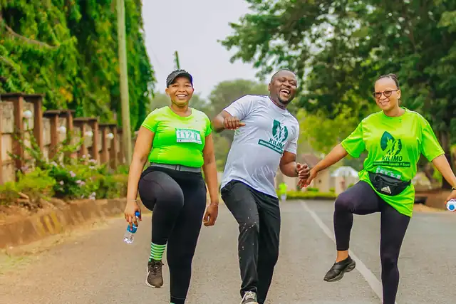 Three runners dancing for joy on the road